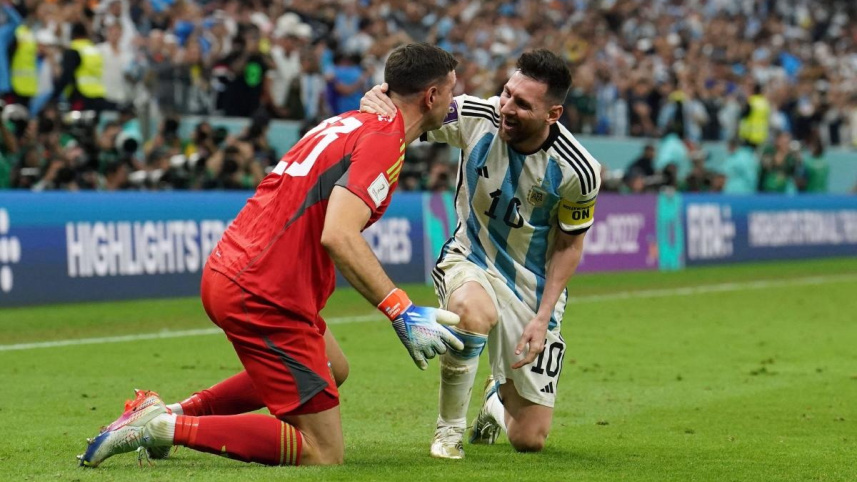 Lionel Messi and Emiliano Martinez